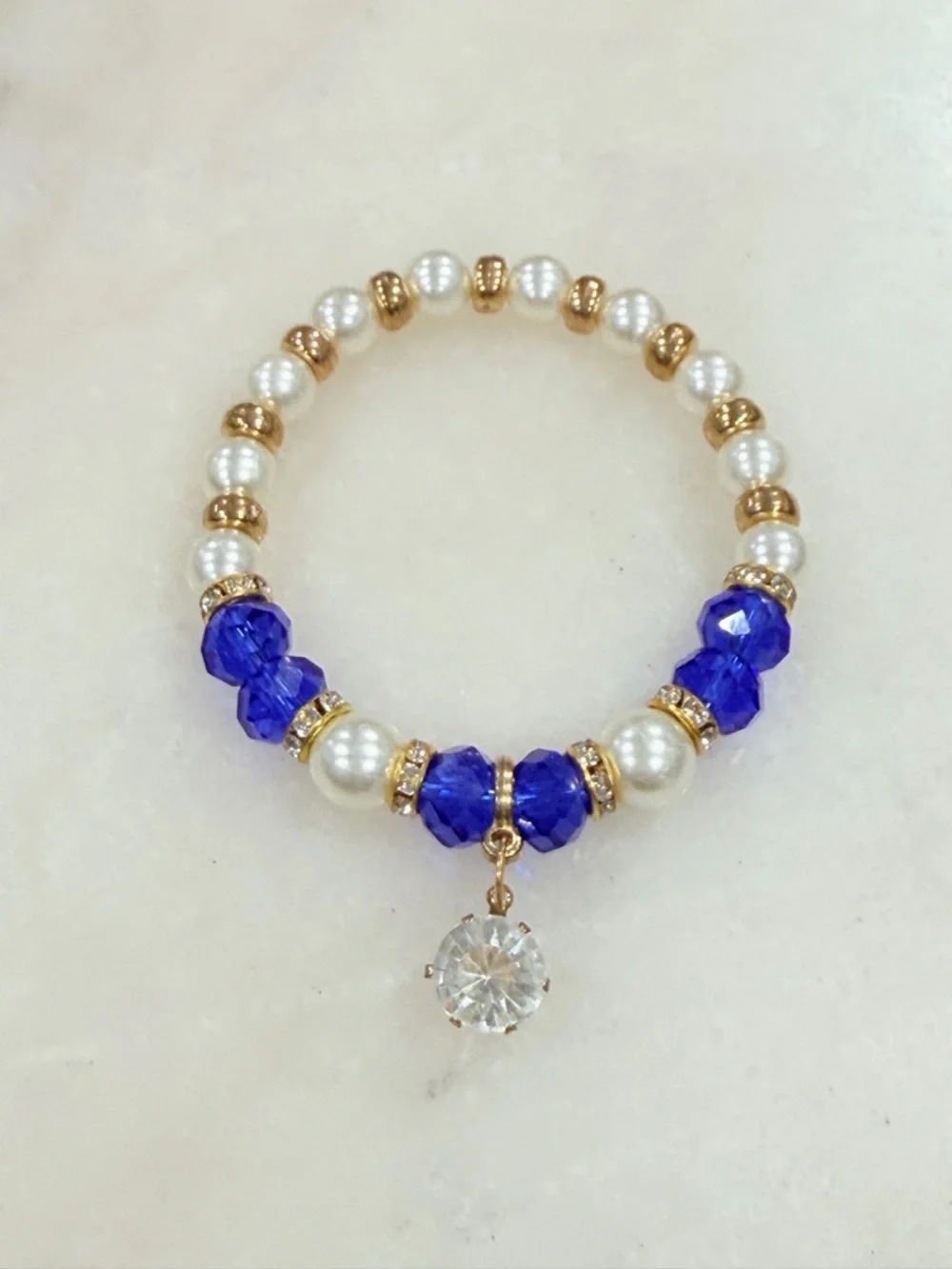 Gold and Pearl Beaded Stretch Bracelet with Blue Crystal Accents and Charm